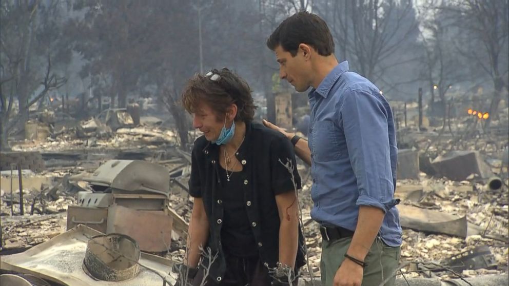 PHOTO: ABC News' Matt Gutman comforted Kris Pond as she searched for her wedding ring in the ashes and debris where her home once stood in northern California.