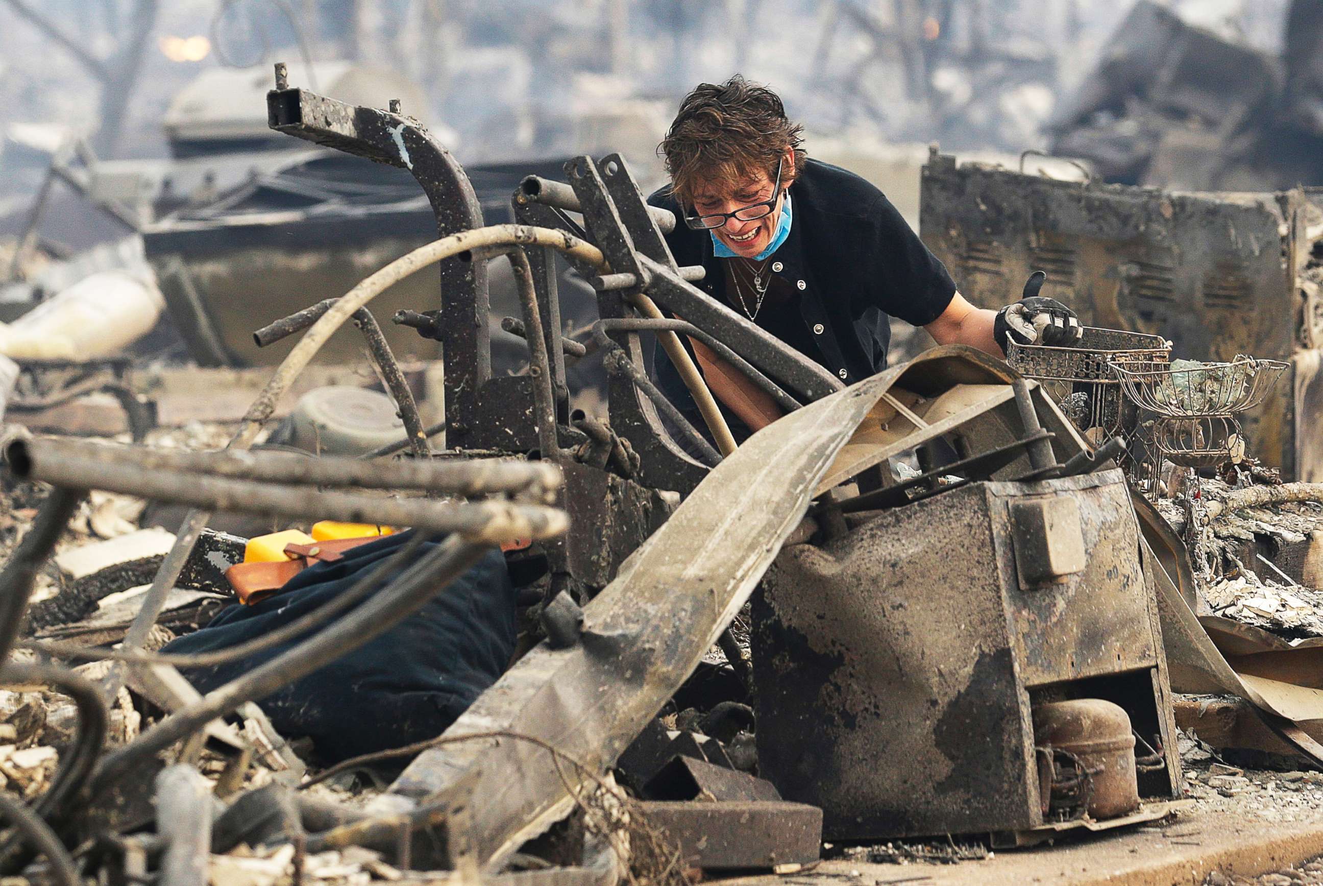 PHOTO: Kris Pond reacts as she searches the remains of her family's home destroyed by fires in Santa Rosa, Calif., Oct. 9, 2017.