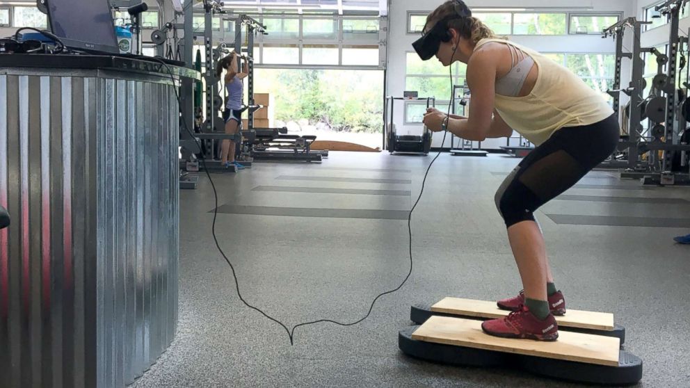 PHOTO: U.S. Olympic Alpine ski racer Laurenne Ross stands on a ski simulator while using virtual reality technology during a training session.