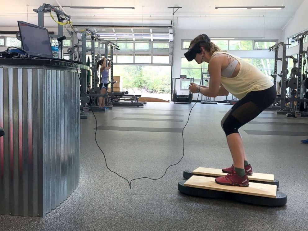 PHOTO: U.S. Olympic Alpine ski racer Laurenne Ross stands on a ski simulator while using virtual reality technology during a training session.