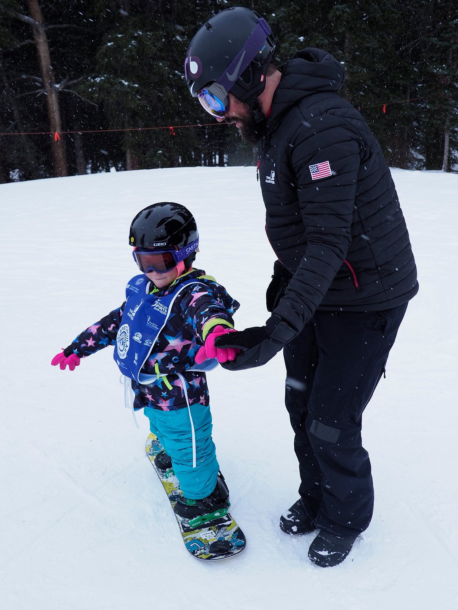 PHOTO: Lilly Biagini, 10, snowboards in Breckenridge, Colorado, with Keith Gabel, a U.S. Paralympian and bronze medalist in snowboarding.