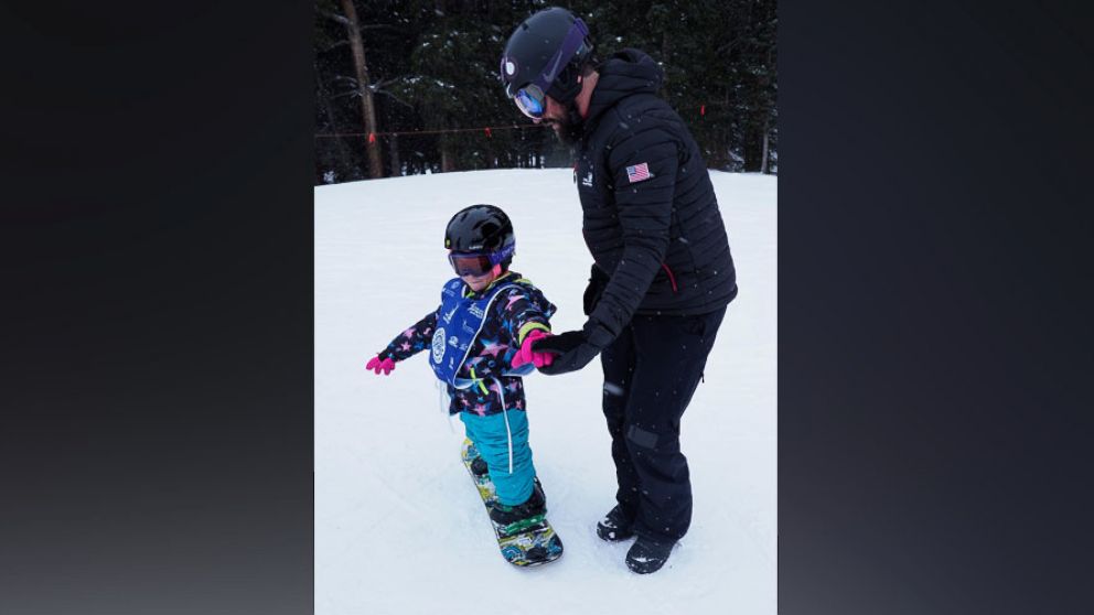 PHOTO: Lilly Biagini, 10, snowboards in Breckenridge, Colorado, with Keith Gabel, a U.S. Paralympian and bronze medalist in snowboarding.