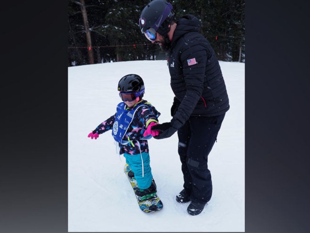 PHOTO: Lilly Biagini, 10, snowboards in Breckenridge, Colorado, with Keith Gabel, a U.S. Paralympian and bronze medalist in snowboarding.