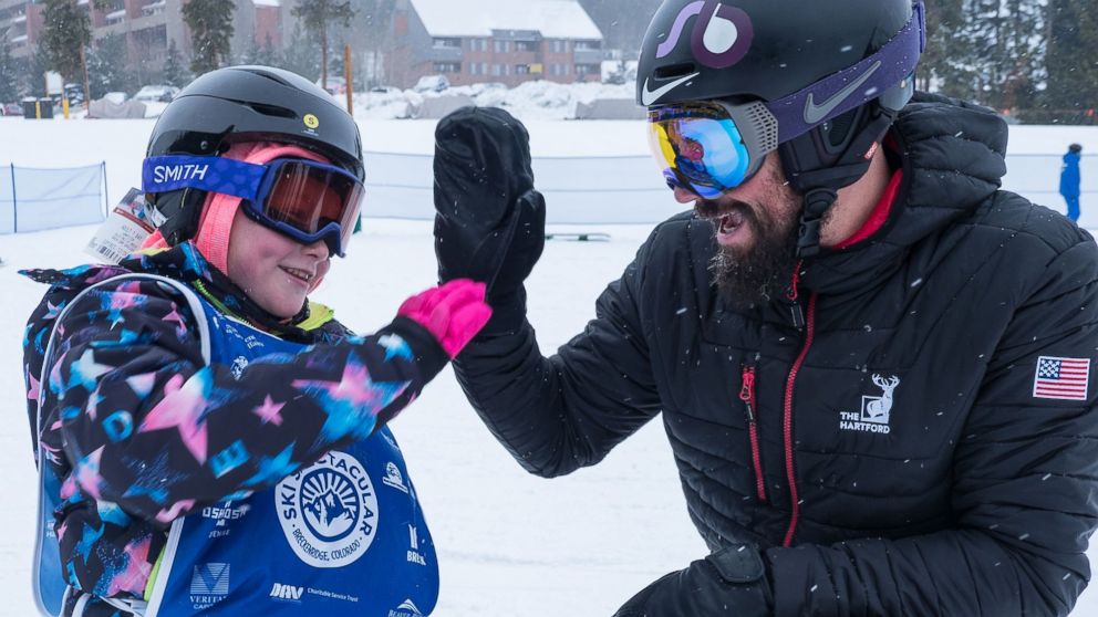 PHOTO: Lilly Biagini, 10, gives Keith Gabel, a U.S. Paralympian, a high five.