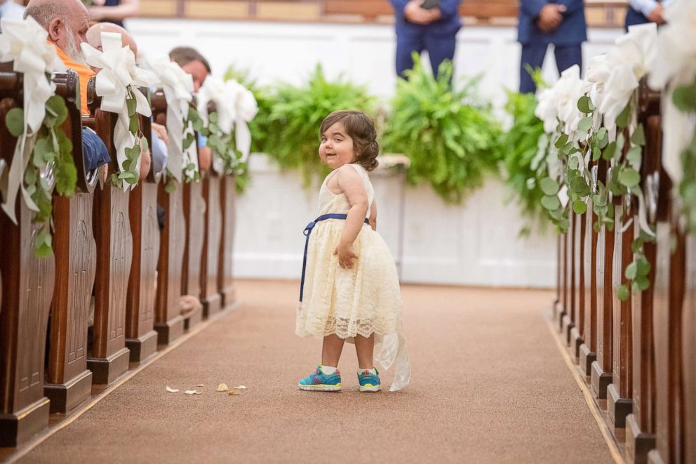 PHOTO: Skye Savren-McCormick, 3, walks down the aisle as the flower girl for her bone marrow donor's wedding on June 9, 2018.