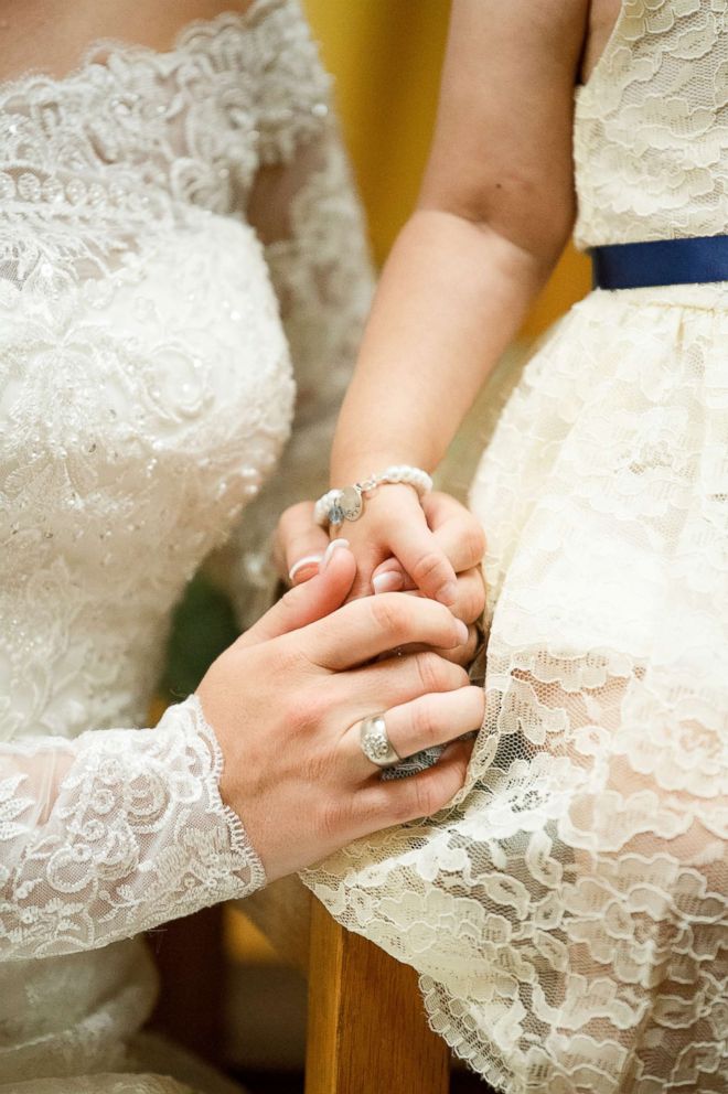 PHOTO: Skye Savren-McCormick holds hand with her bone marrow donor, Hayden Hatfield Ryals on her wedding day, June 9, 2018.