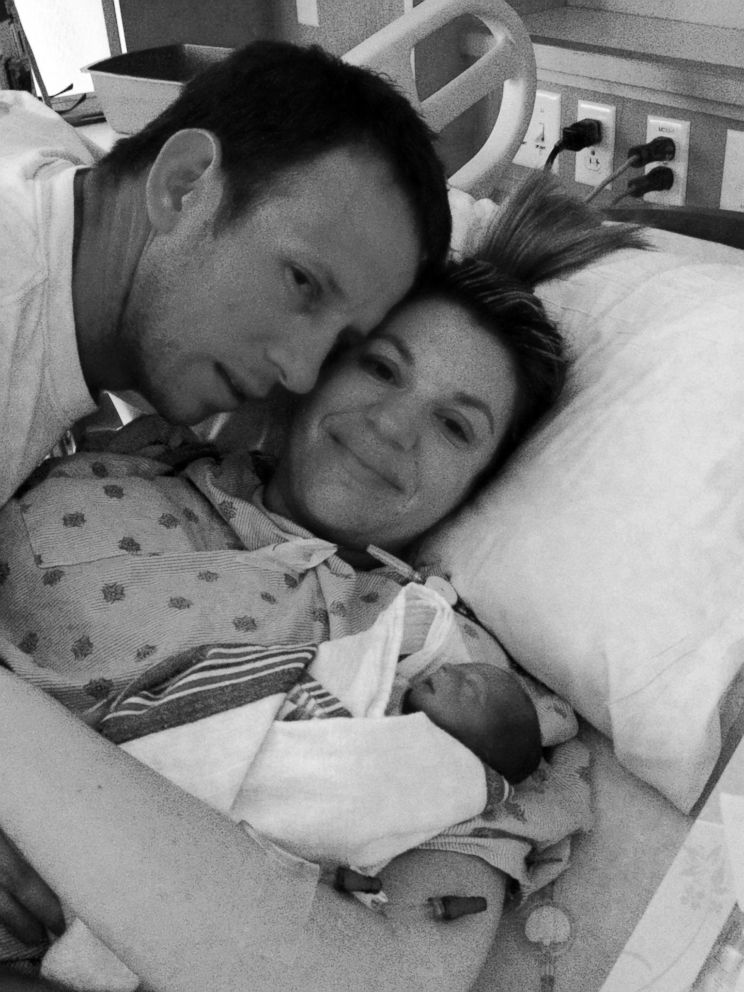 PHOTO: Stacey Skrysak, pictured here with her husband and now-deceased daughter was criticized by commenters for smiling as she held her dying child. 