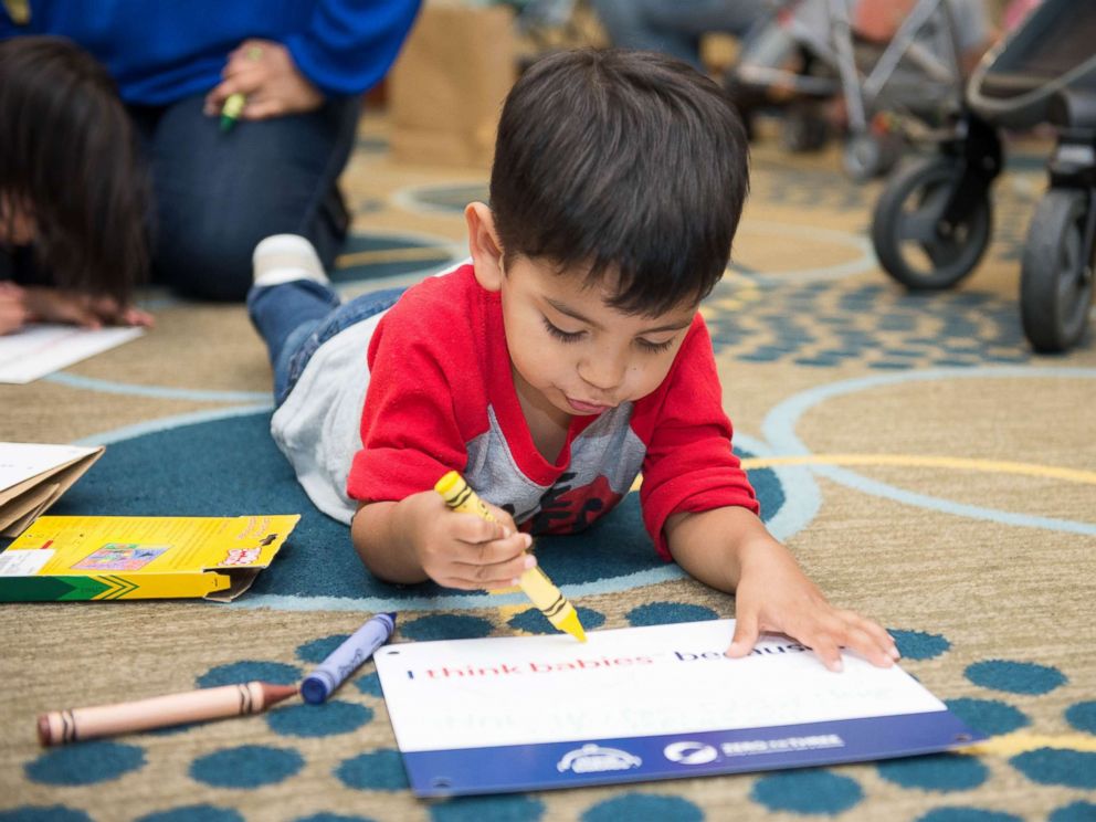 PHOTO: A young Strolling Thunder participant decorates a sign to hang on his stroller on Capitol Hill.