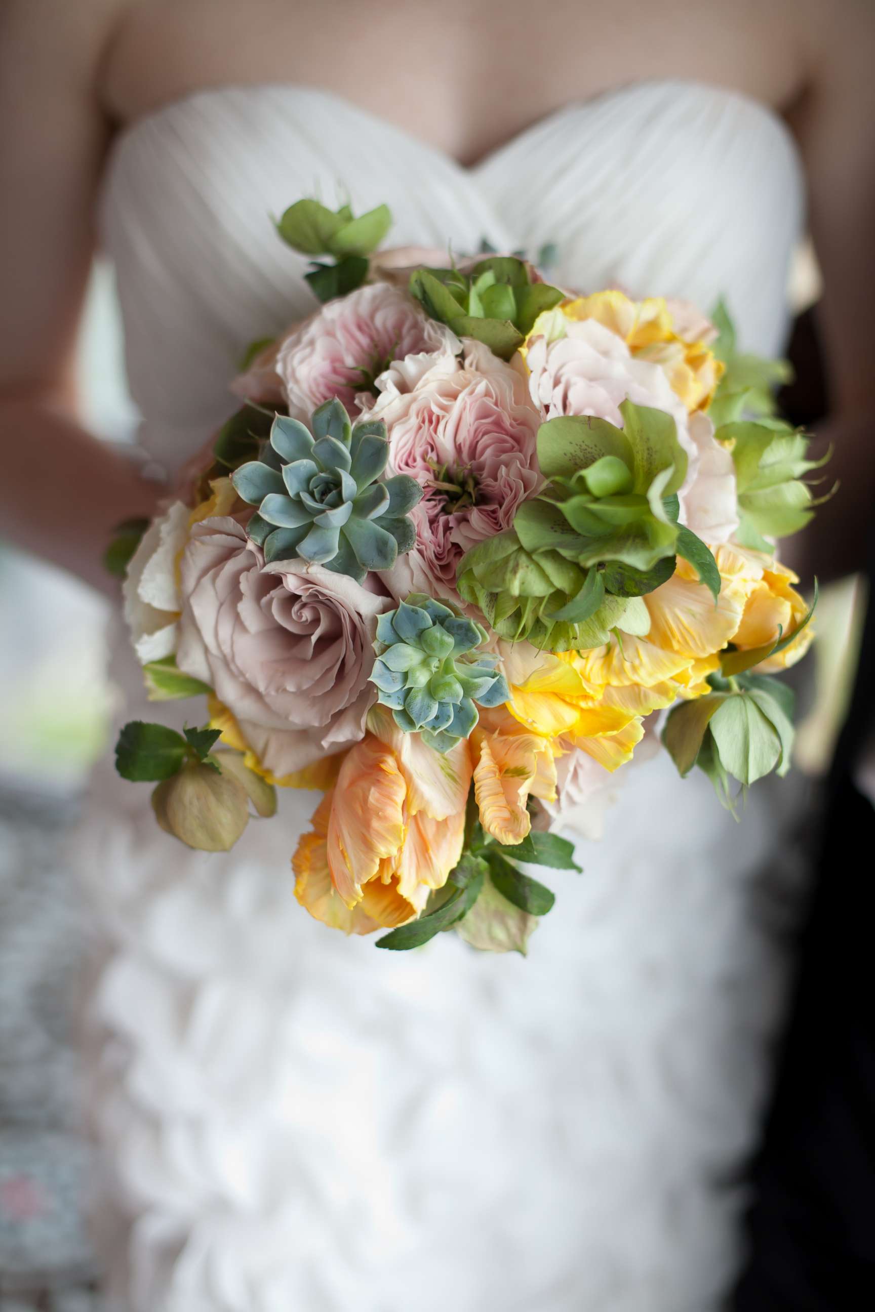 PHOTO: A bride holds a bouquet of roses, garden roses, tulips and succulents in an undated stock photo.