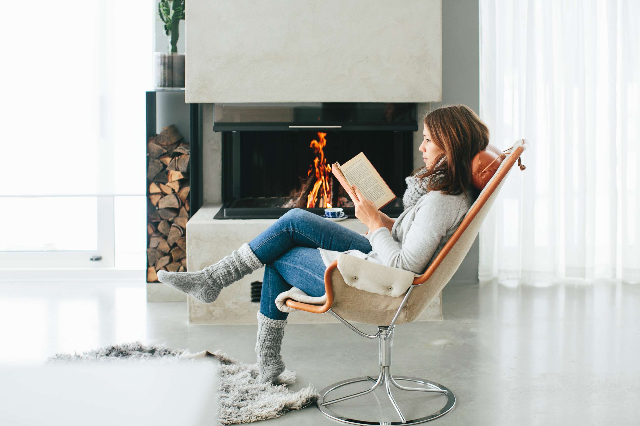 PHOTO:An undated stock photo of woman reading a book in front of fireplace in Sweden. 
