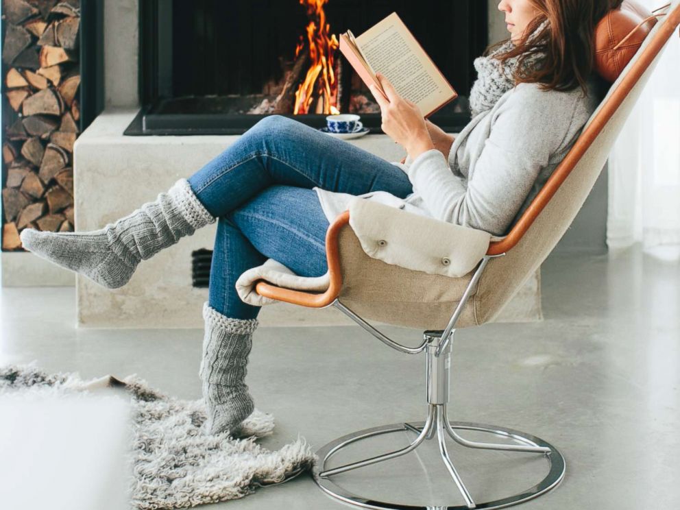 PHOTO:An undated stock photo of woman reading a book in front of fireplace in Sweden.