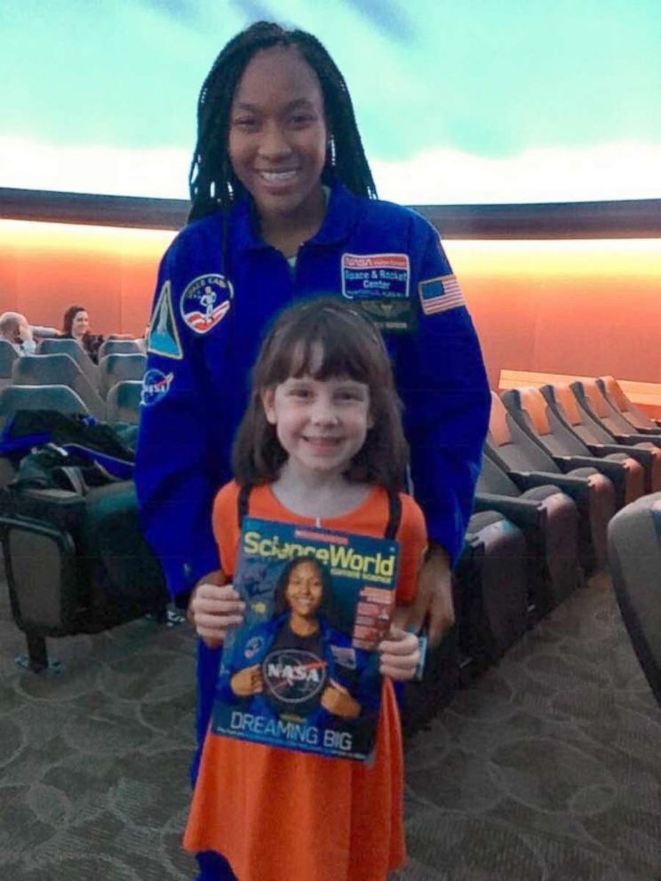 PHOTO: Taylor Richardson with a young fan holding the October issue of "Scholastic Science World."