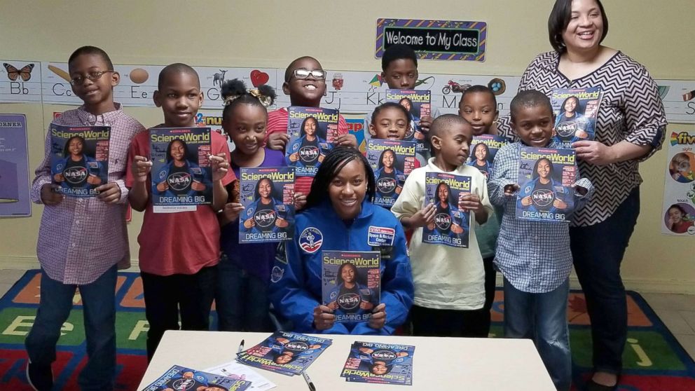 PHOTO: Taylor Richardson with a class of students holding the October issue of "Scholastic Science World."