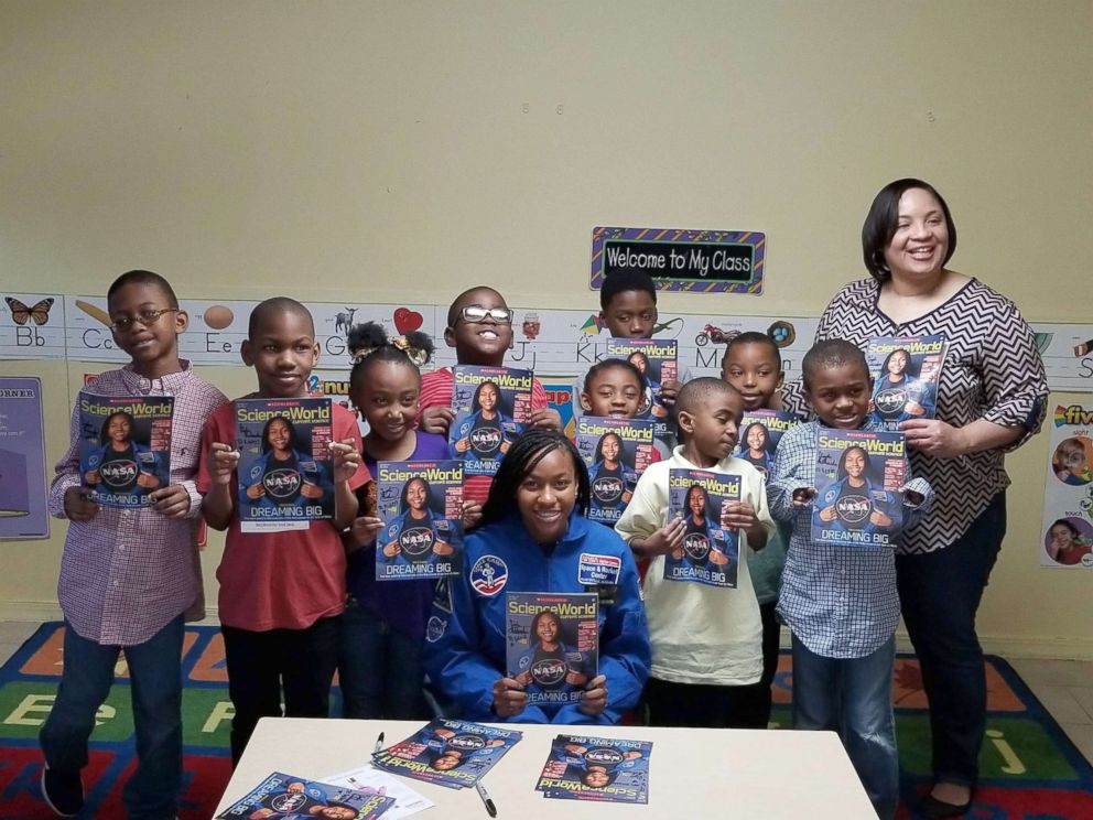 PHOTO: Taylor Richardson with a class of students holding the October issue of "Scholastic Science World."