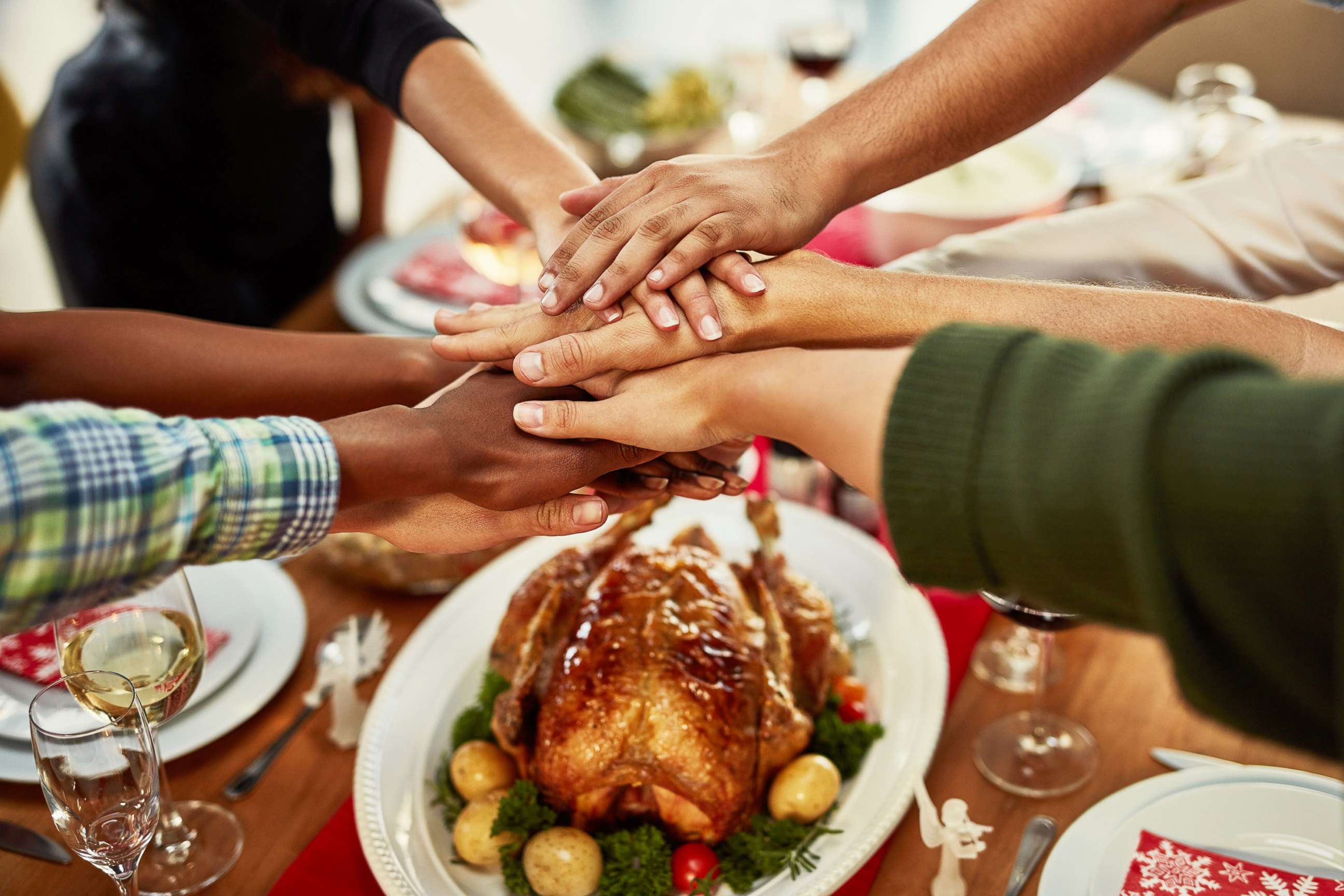 PHOTO: A family stacks their hands in celebration before a special dinner. 