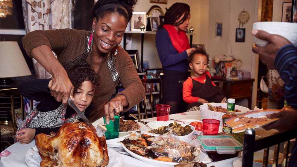 A family gathers around the dinner table. 