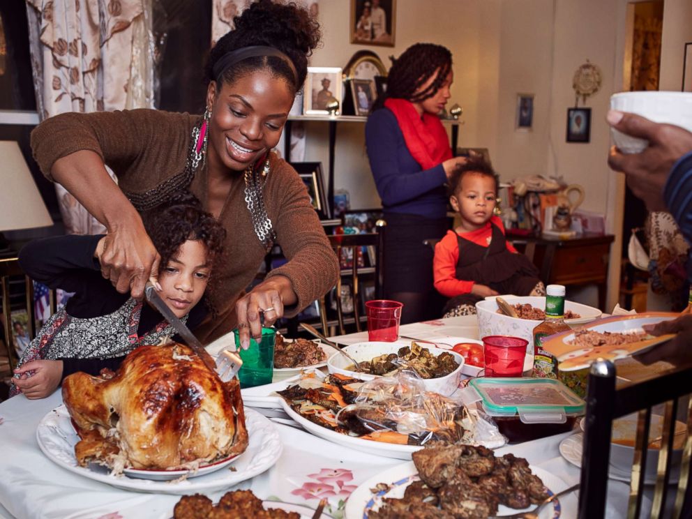 PHOTO: A family gathers around the dinner table.