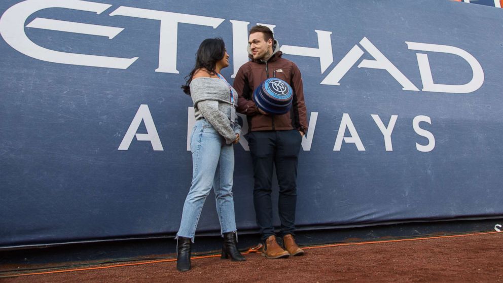 PHOTO: Alexa Valiente and her Tinder date Walter prepare to light the NYCFC Smoke Stacks and start the game on April 29, 2018. 