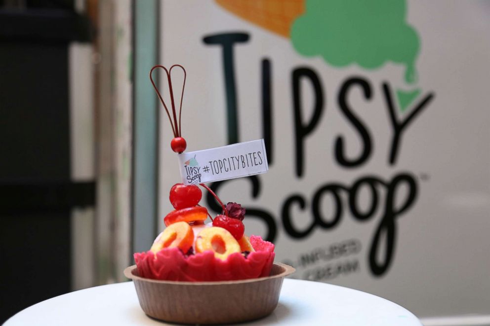 PHOTO: Frose all day sundae with peach gummies and rose petals served in a hot pink waffle cone bowl.