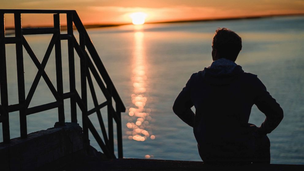 PHOTO: A man sits by the water in this undated file photo.