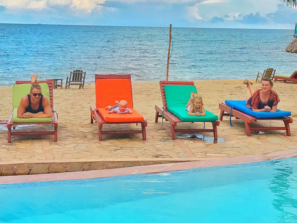 PHOTO: Karen Edwards and Shaun Bayes pose poolside with their children, Esme and Quinn.