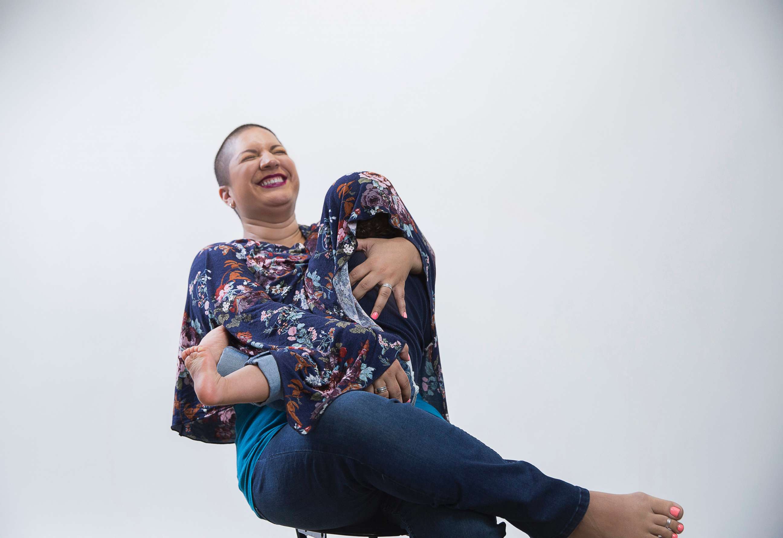 PHOTO: A woman poses while breastfeeding in a photo session for the 2018 Make the Breast Pump Not Suck Hackathon.