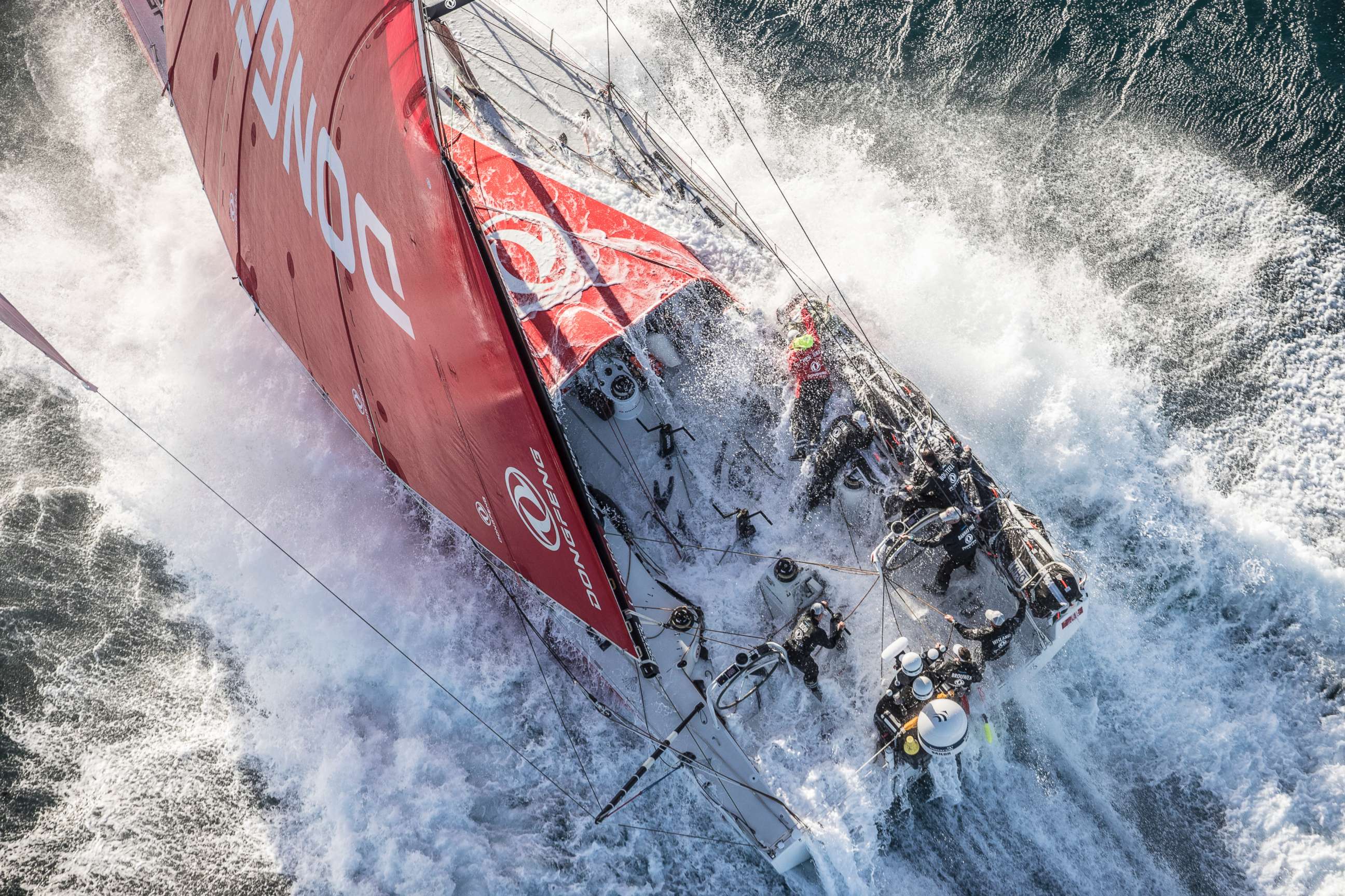 PHOTO: The DongFeng race team, which includes female crew members Carolijn Brouer Marie Riou, and Justine Mettraux, braves the waves at the start of Leg 2 from Lisbon to Cape Town on Nov. 2017.