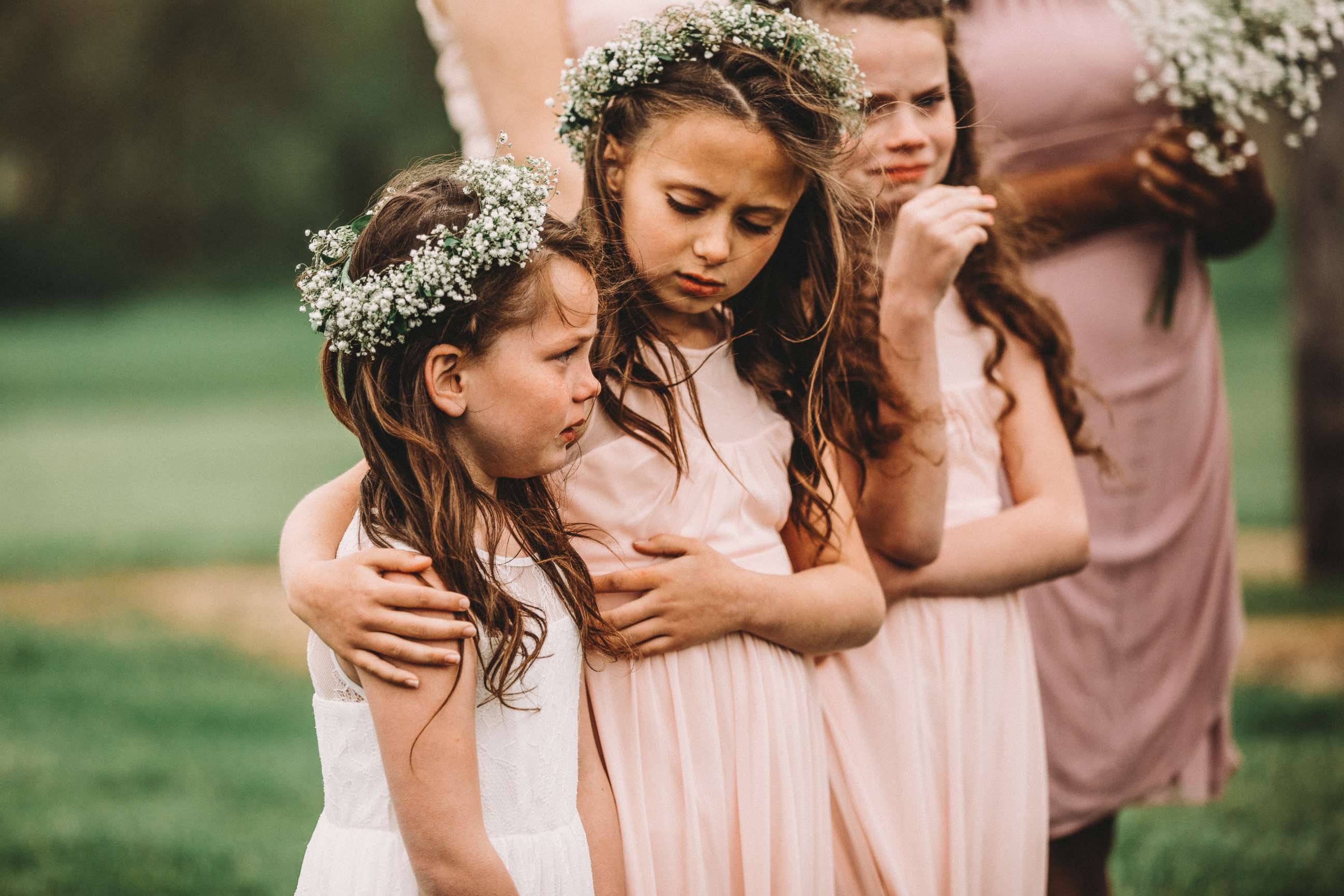 PHOTO: Riley Gibson, 8, comforts her sister Lexi, 6, on May 12 at their parents' wedding in Iowa.