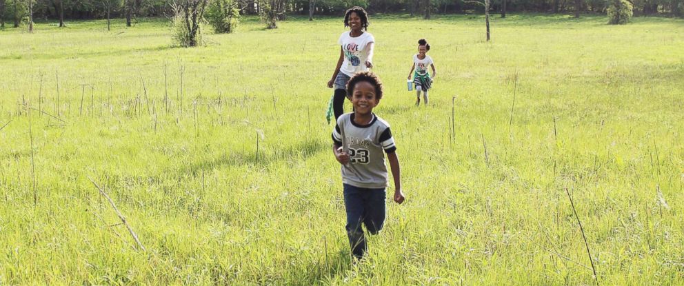 PHOTO: Samuel White, 7, Nakiah White, 12, and Ava White, 10, run outside together.