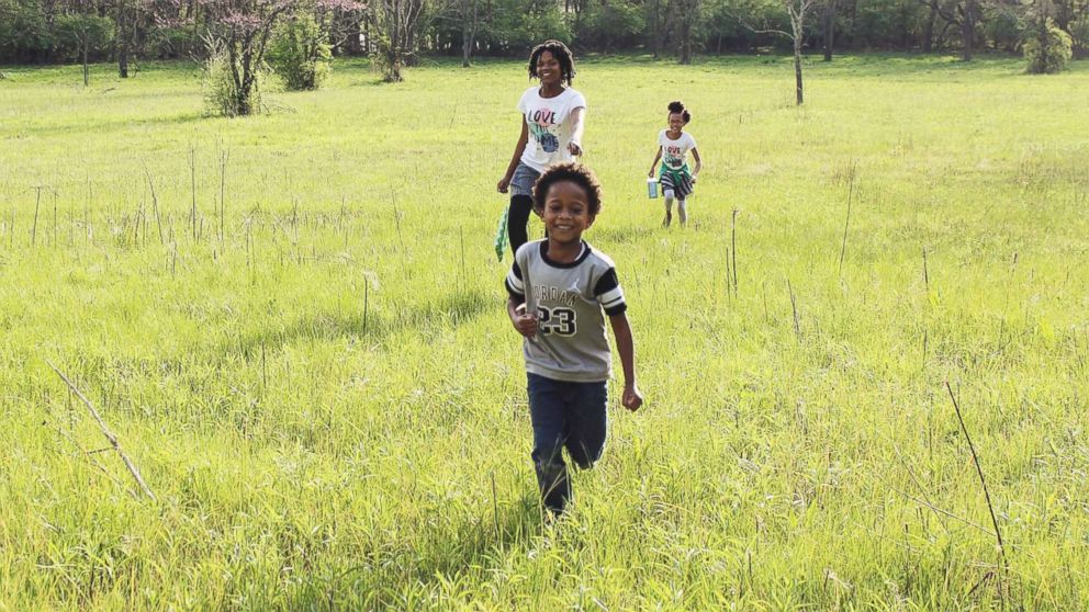 PHOTO: Samuel White, 7, Nakiah White, 12, and Ava White, 10, run outside together.