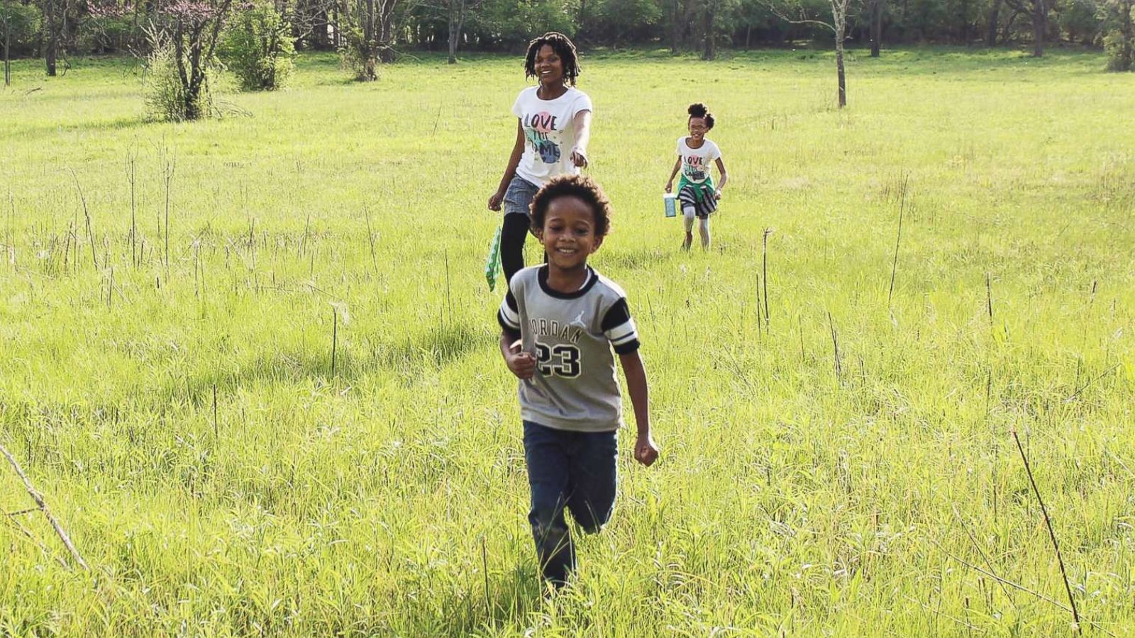 PHOTO: Samuel White, 7, Nakiah White, 12, and Ava White, 10, run outside together.