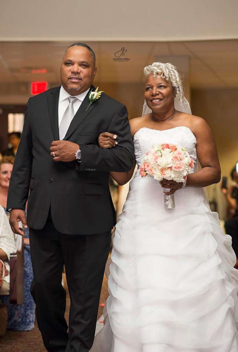 PHOTO: Lucinda Myers, 67, walks down the aisle with her son-in-law Rodney Whitlow, at First Seventh-day Adventist Church in Huntsville, Alabama on July 29.
