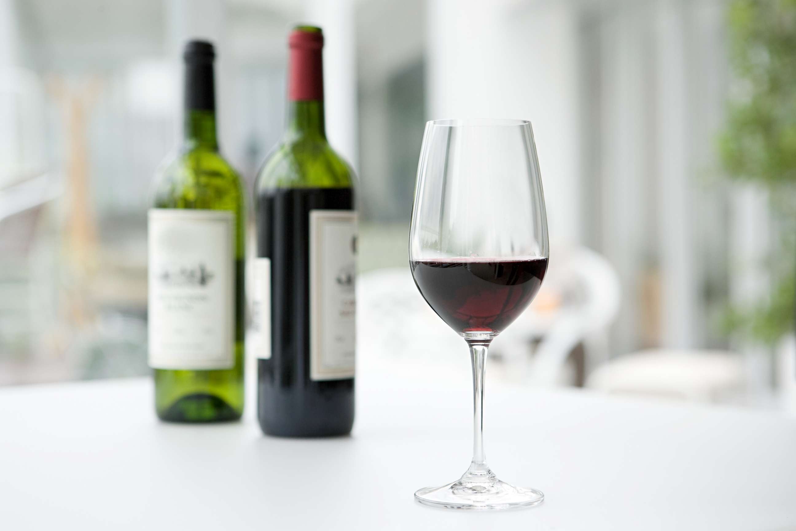 PHOTO: In this undated stock photo is a glass of red wine in front of bottles of wine.