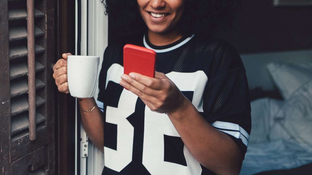 A young woman uses a smartphone in an undated stock photo. 
