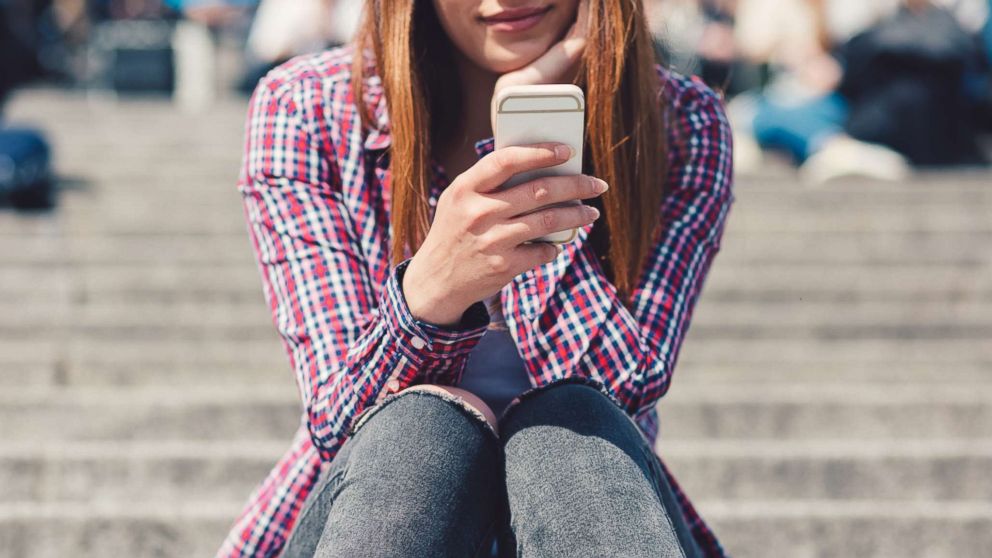 PHOTO: A young woman uses a smartphone in an undated stock photo. 