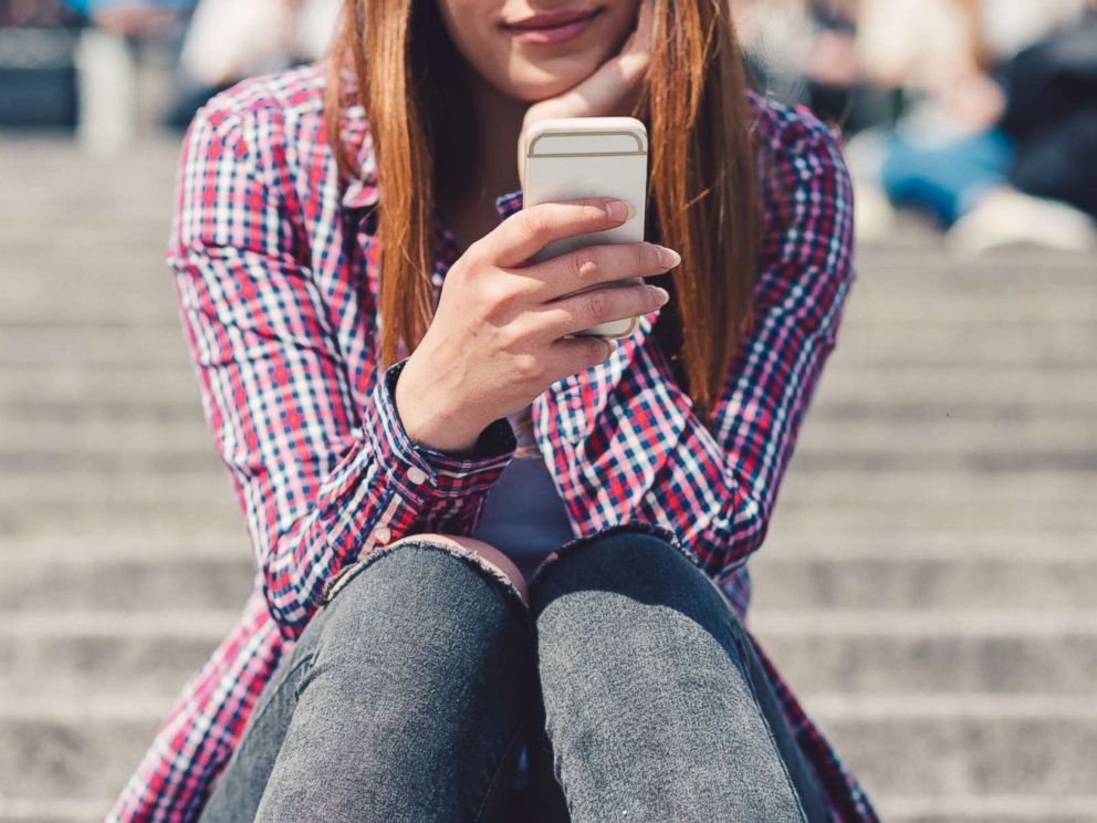 PHOTO: A young woman uses a smartphone in an undated stock photo.