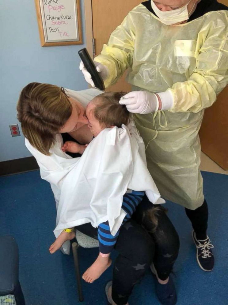 PHOTO: Nichole Brooks and her son Wyatt as he gets a haircut before his hair fell out from chemotherapy. 