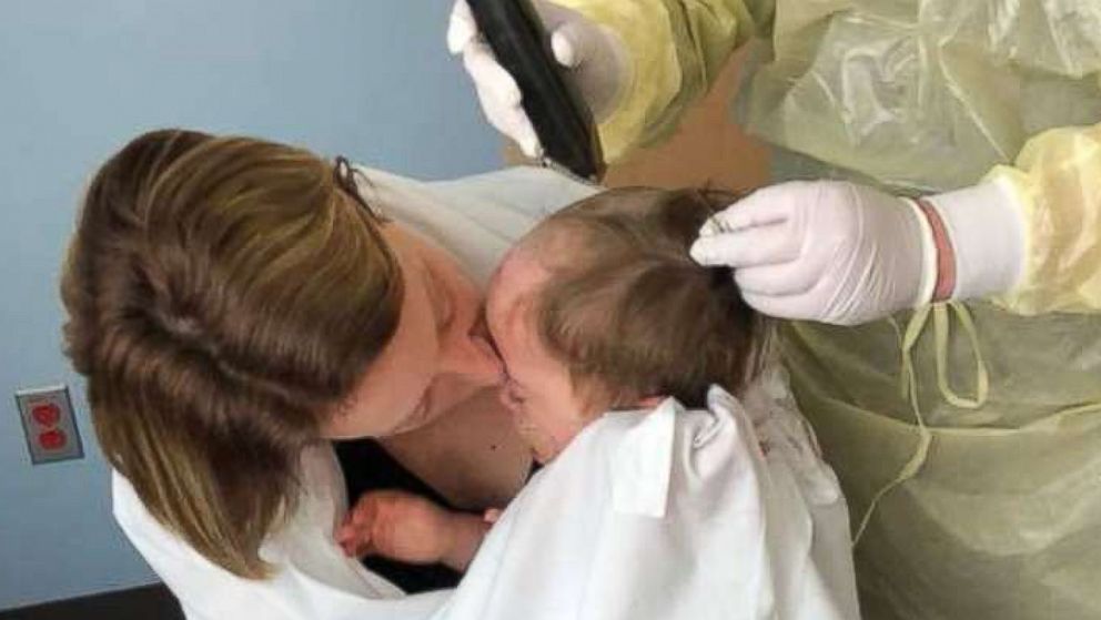 PHOTO: Nichole Brooks and her son Wyatt as he gets a haircut before his hair fell out from chemotherapy.