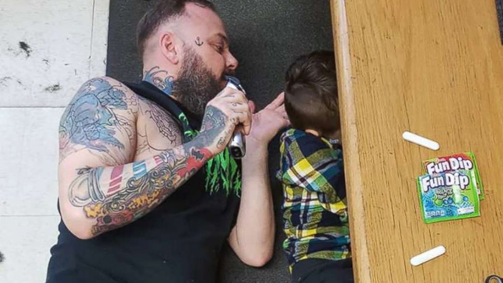 Franz Jakob, a barber in Rouyn-Noranda, Quebec, had to go onto the floor to cut Wyatt Lafreniere. The 6-year-old boy has autism with sensory issues.
