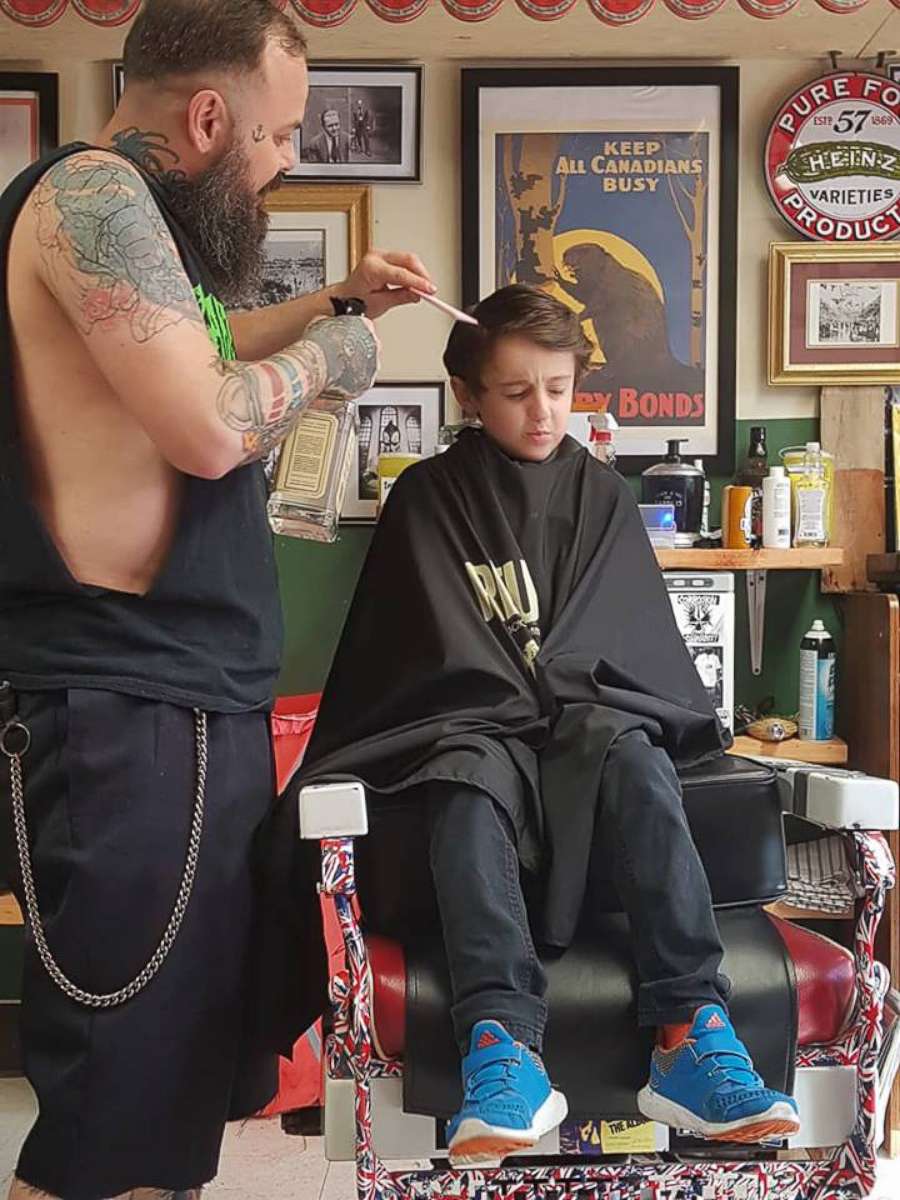 PHOTO: Franz Jakob, a barber in Rouyn-Noranda, Quebec, had to go onto the floor to cut Wyatt Lafreniere. The 6-year-old boy has autism with sensory issues.