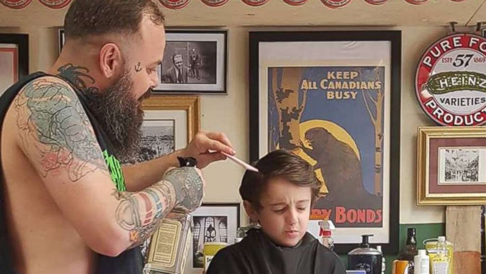 PHOTO: Franz Jakob, a barber in Rouyn-Noranda, Quebec, had to go onto the floor to cut Wyatt Lafreniere. The 6-year-old boy has autism with sensory issues.