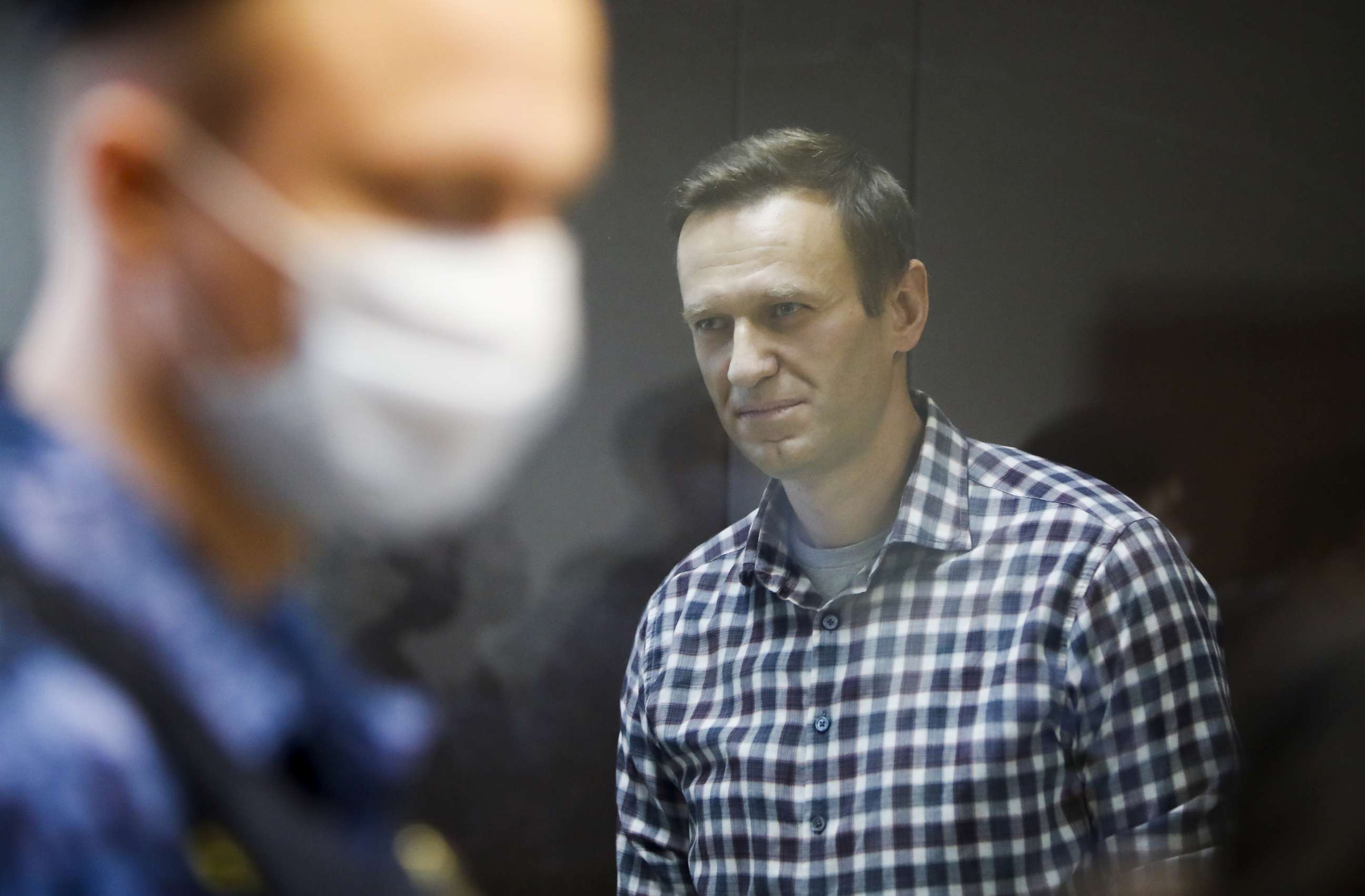 FILE PHOTO: Russian opposition politician Alexei Navalny attends a hearing to consider an appeal against an earlier court decision to change his suspended sentence to a real prison term, in Moscow, Russia February 20, 2021. 