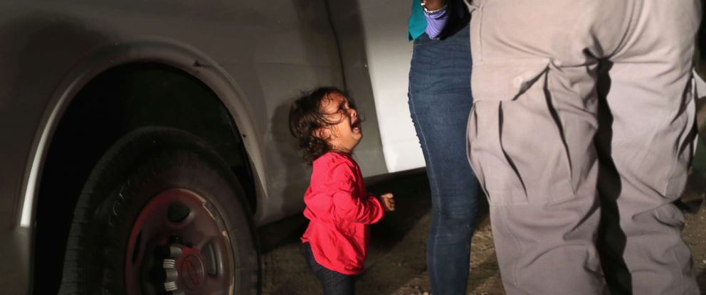 PHOTO: A two-year-old Honduran asylum seeker cries as her mother is searched and detained near the U.S.-Mexico border on June 12, 2018, in McAllen, Texas. 