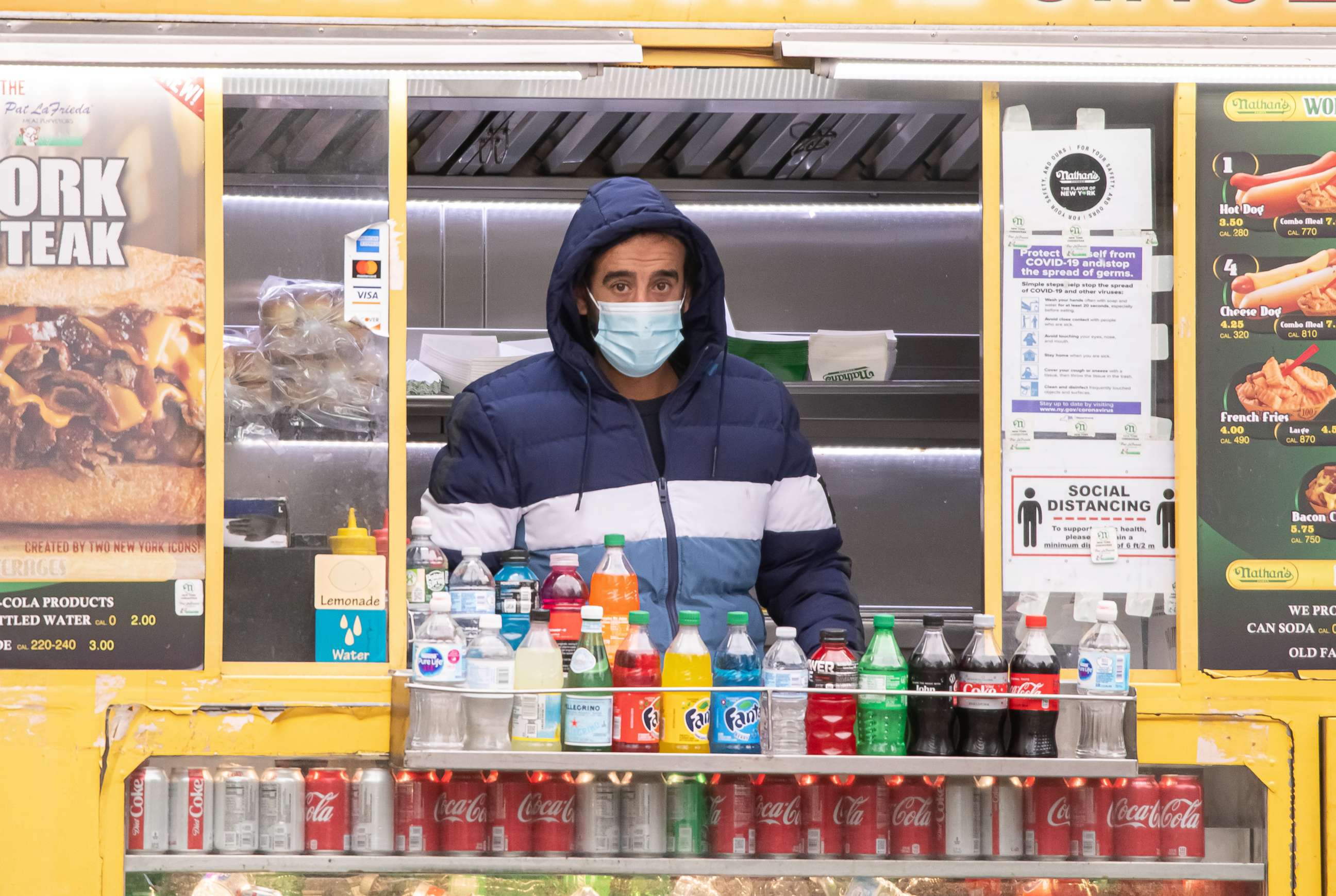 PHOTO: In this Dec. 31, 2020, file photo, a worker wears a face mask inside a food truck in Columbus Circle in New York.