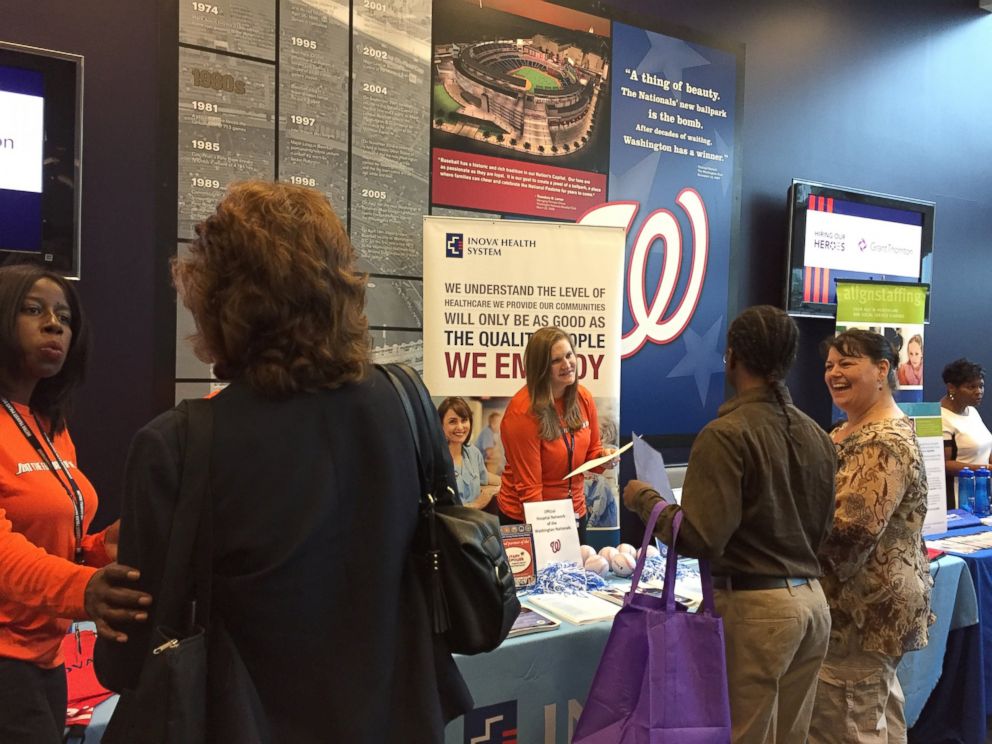 PHOTO: Veterans and military spouses in Washington talk with employers at Nationals Park.