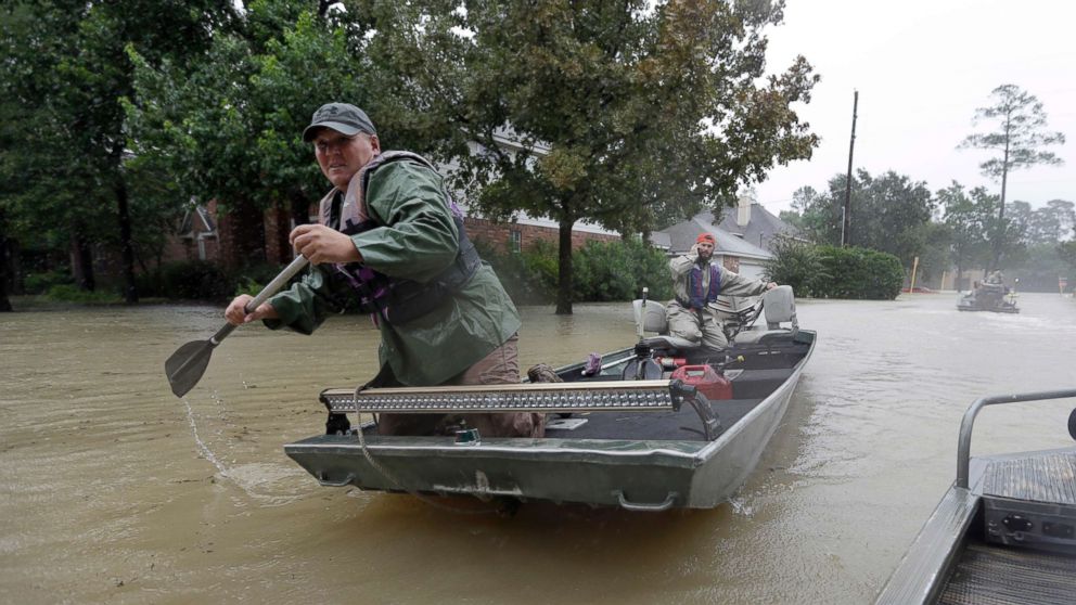 PHOTO: Volunteers use their boat to help evacuate residents as floodwaters from Tropical Storm Harvey rise Monday, Aug. 28, 2017, in Spring, Texas.