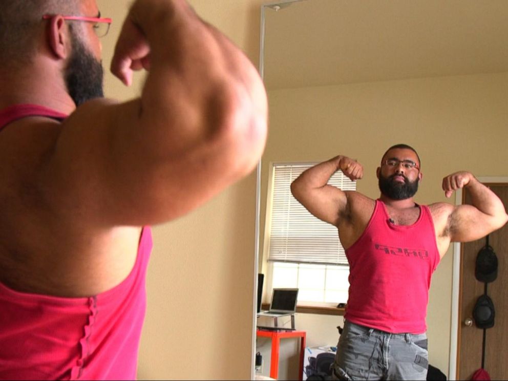 He has bulked out. A muscular bodybuilder flexing his muscles