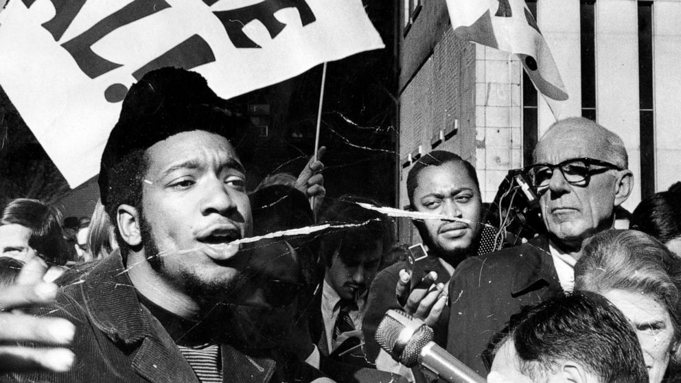 PHOTO: Fred Hampton, left, head of the Illinois Black Panthers, and Dr. Benjamin Spock, right, attend a rally against the trial of eight people accused of conspiracy to start a riot at the Democratic National Convention.