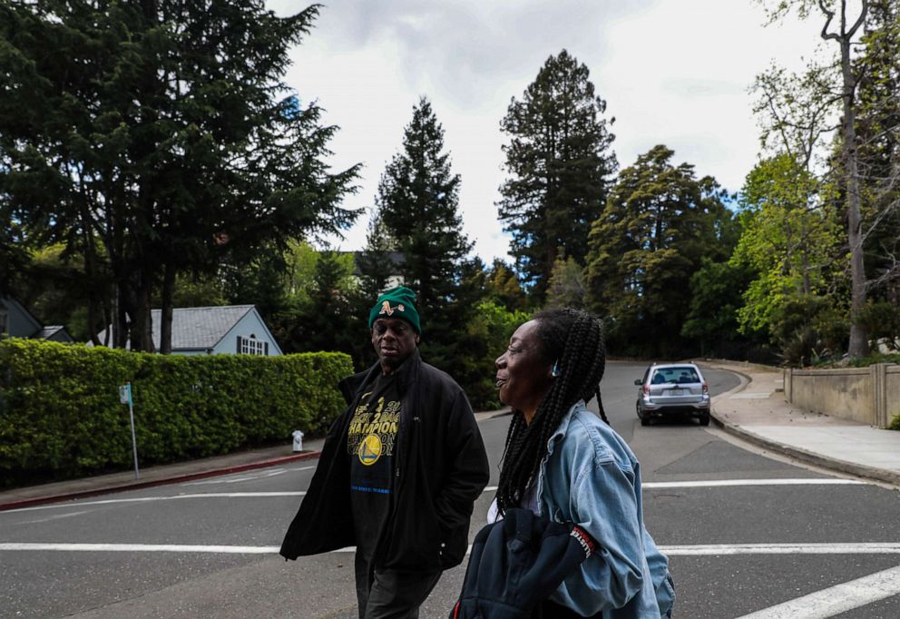 PHOTO: Greg Dunston, Sr. and his partner Marie Mckinzie walk back home after visiting Hampton Park, in Piedmont, Calif., on April 16, 2019.