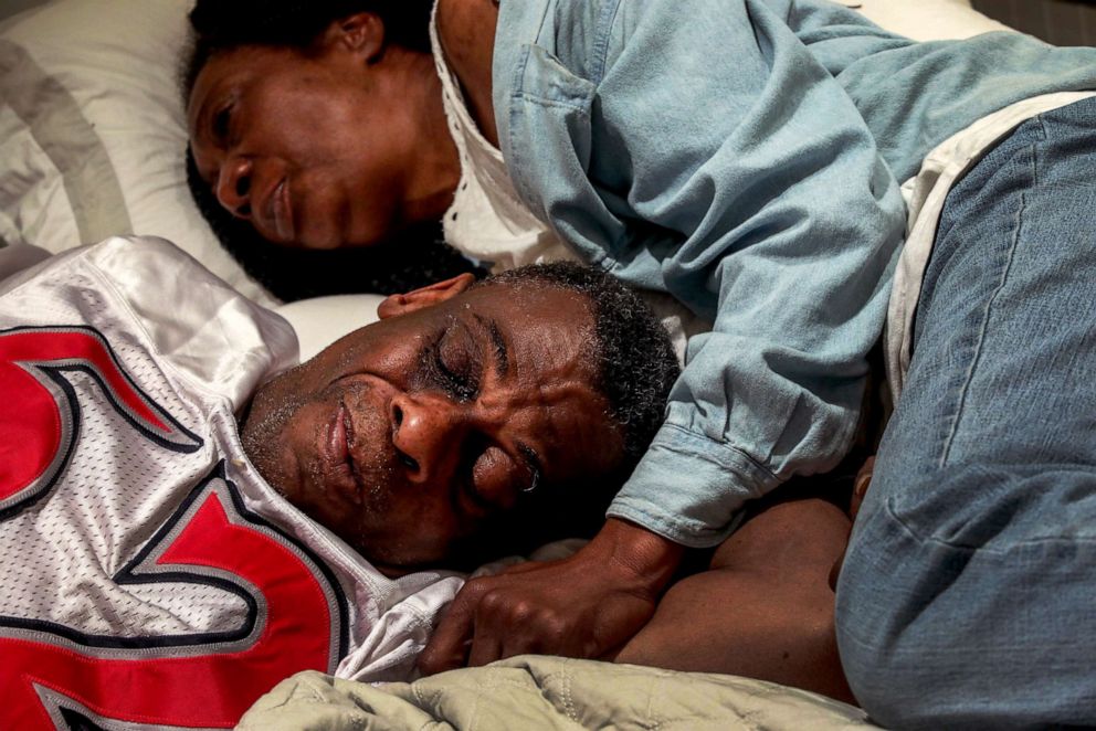 PHOTO: Marie Mckinzie, 54, and her partner, Greg Dunston, Sr., rest in bed inside the basement apartment where they've been living since February, in Piedmont, Calif., on  April 18, 2019.